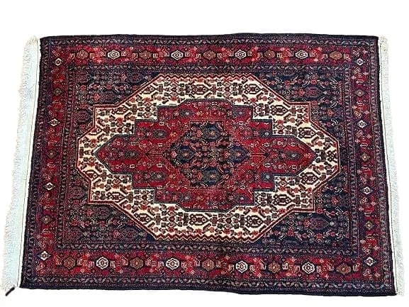 A Persian Kurdish Senneh wool scatter rug: A Persian Kurdish Senneh wool scatter rug measuring 47 inches wide by 65 inches long. A finely woven tribal hand knotted single wefted weaving Persian Senneh rug.