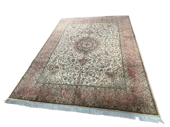 A Persian Tabriz Fine large room size rug 10 by 13: A Persian Tabriz Fine large room size rug 10 feet wide by 13 feet long. A finely woven used Persian Tabriz wool & silk highlighted rug with a cotton foundation. An intricate floral design with a cente
