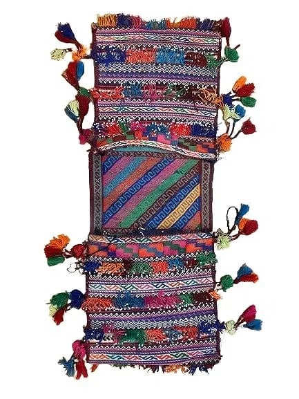 A Balouch hand woven Saddle bag: An old Afghan Balouch hand woven Saddle bag measuring 34 inches long by 13 inches long.