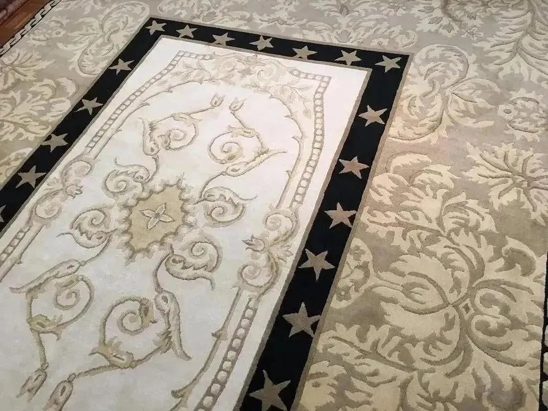 A handwoven Tibetan Contemporary wool rug: A hand woven Tibetan Contemporary wool rug Measuring 9 ft 11 inches wide by 11 ft 10 inches long.