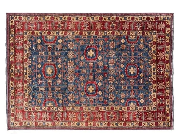 A Pakistan Kazak room size rug: A Pakistan Kazak room size rug measuring 9 feet wide by 12 feet 4 inches long. A finely woven wool on wool Caucasian design hand woven rug.