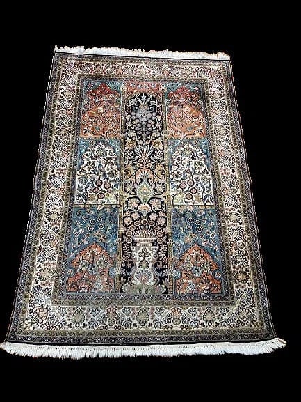 An Indian Kashmiri Silk Scatter rug: An Indian Kashmiri Silk Scatter rug measuring 4 feet wide by 6 feet long. A finely woven hand made rug from India.