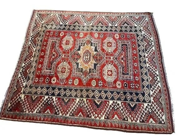 A Pakistan Kazak Handwoven wool rug: A Pakistan Kazak Handwoven wool rug. A Caucasian Kazak design geometric pure wool hand woven rug from Pakistan. measuring 6 feet 9 by 6 feet 2 inches.