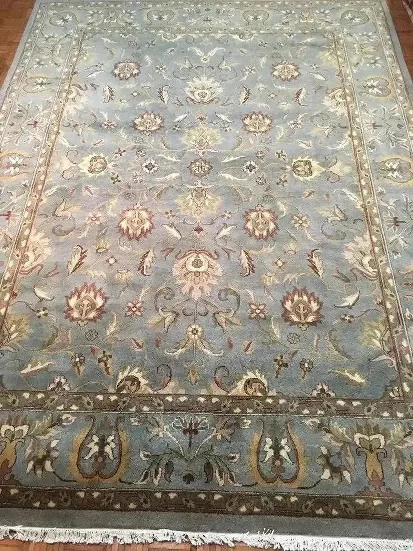 A handwoven Indian Agra wool Rug: A hand woven Indian Agra wool Rug. Measuring 9 ft wide by 12 ft long.