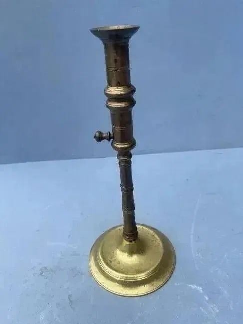 A Brass Candlestick with ejector: A brass ejector candlestick. A Metropolitan Museum reproduction vintage brass Candlestick.