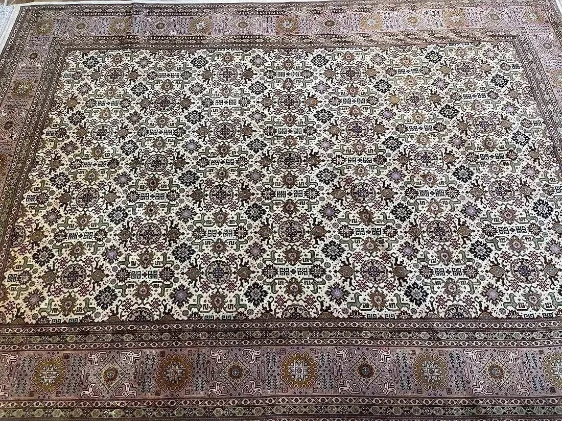 A Persian Tabriz rug: A Persian Tabriz rug measuring 6 feet 3 inches wide by 9 feet 3 inches long. A finely woven wool on cotton Persian rug with a Caucasian Kuba Afshan design.
