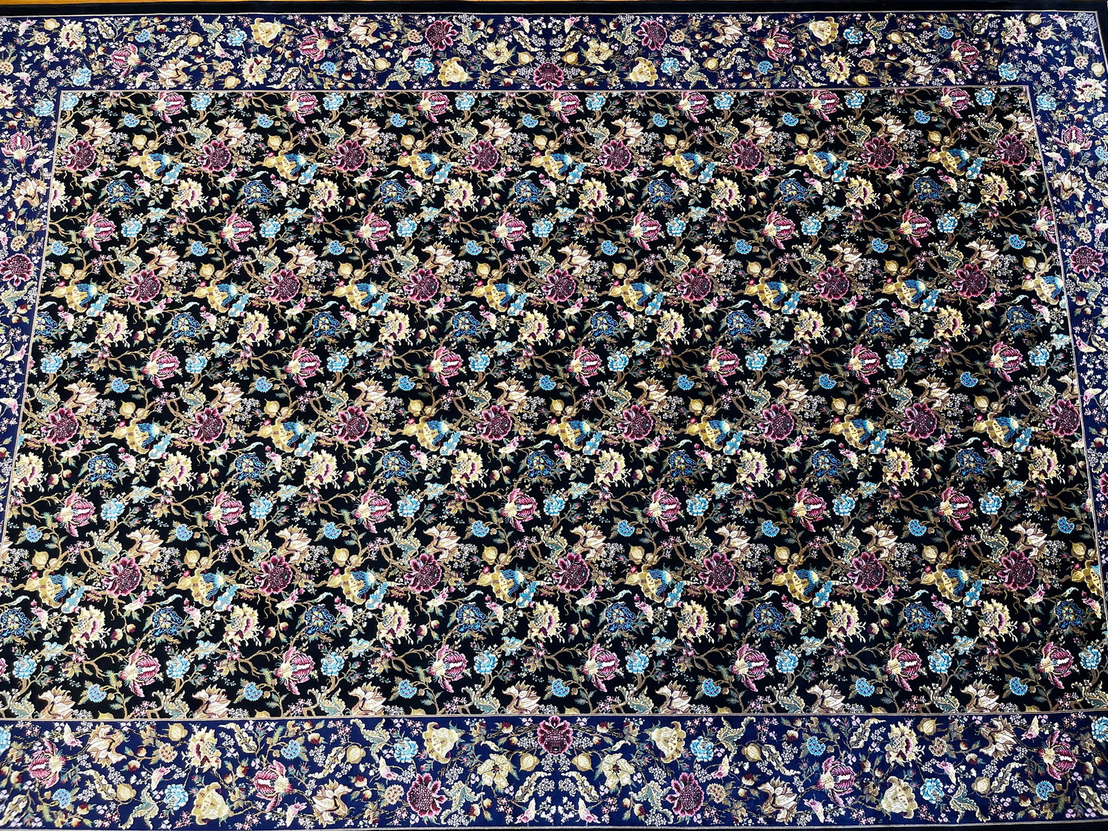 A Persian Silk Qum machine woven hand fringed rug: A Persian Silk Qum machine woven hand fringed rug measuring 4 feet 10 inches by 7 feet 6 inches long. A beautiful Brand New never used floral design rug. We Offer In house shipping to any USA