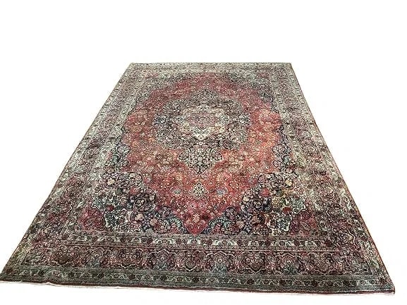Antique Persian Sarouk room size rug: Antique Persian Sarouk room size rug measuring 8 feet 9 inches wide by 13 feet long. A wool hand knotted Persian rug with a floral center medallion design. Please read the condition report below befor