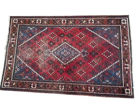 An old Persian Josheghan Hand woven rug: An old Persian Josheghan Hand woven wool rug Measuring 4 ft 5 inches wide by 7 ft 1 inches long. A tribal persian jsheghan snow flake design scatter rug.