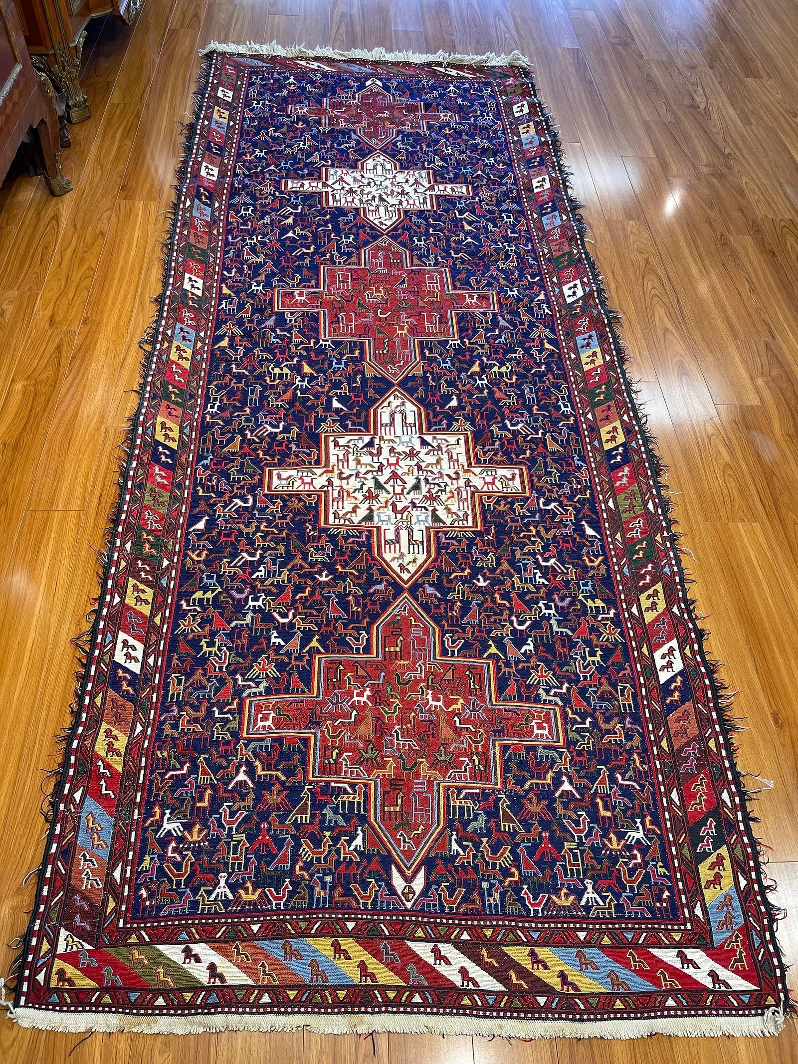 A Persian Qashqai Soumak flat woven tribal wide runner rug: A Persian Qashqai Soumak flat woven tribal wide runner rug measuring g 4 feet wide by 7 feet long. A wool handwoven kilim on cotton foundation. This lot was hung on the wall for many decades and has m