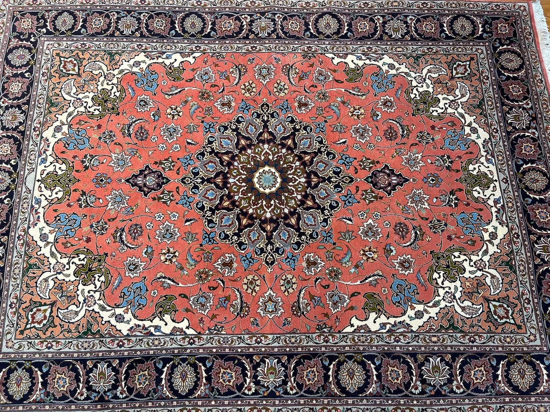 A Persian Tabriz wool & silk rug: A Persian Tabriz wool & silk rug rug measuring 5 feet 1 inches wide by 6 feet 11 inches long. A wool & silk high lighted rug on cotton foundation. A genuine Persian hand knotted fine Tabriz floral des