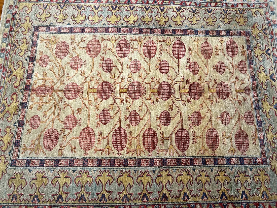A Pakistan Handwoven Khotan Pomegranate design wool Rug: A Pakistan Handwoven Khotan Pomegranate design handwoven wool Rug. A hand knotted wool rug measuring 6 feet wide by 7 feet 3 inches long.
