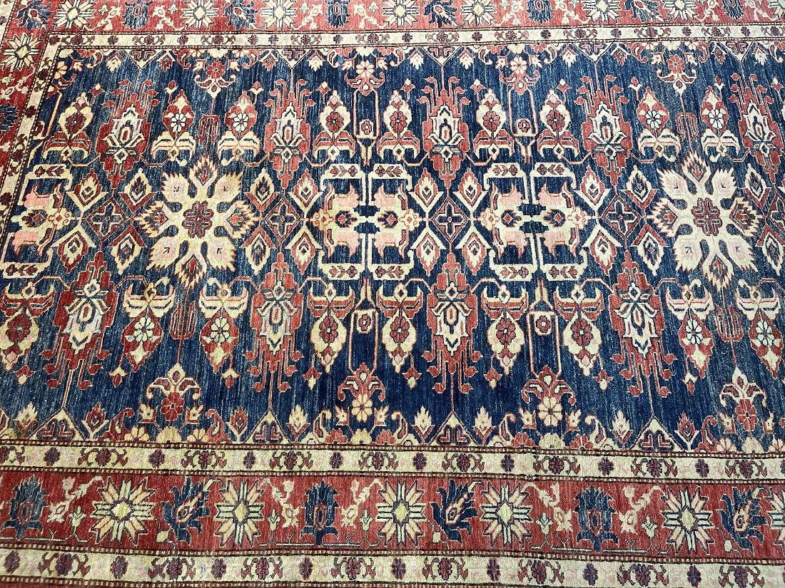 A Pakistan Kazak handwoven rug: A Pakistan Kazak hand woven rug measuring 5 feet 11 inches wide by 8 feet 8 inches long. A finely woven tribal Caucasian Kazak design made with pure wool.