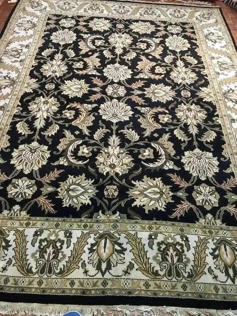 A handwoven Indian Mahal wool rug: A hand woven Indian Agra Mahal wool rug. Measuring 9 ft wide by 12 ft long.