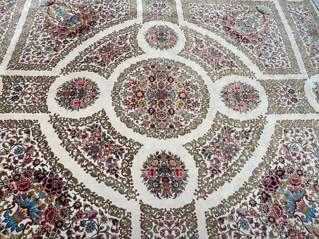 A Persian Silk Qum machine woven hand fringed rug: A Persian Silk Qum machine woven hand fringed rug measuring 6 feet 4 inches by 6 feet 6 inches long. A beautiful Brand New never used floral design rug. We Offer In house shipping to any USA destinati