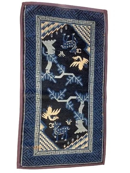 Antique Chinese handwoven Pao Tao rug: Antique Chinese handwoven Pao Tao wool rug measuring 28 inches wide by 52 inches long. A unique design featuring deers & cranes motif framed with revolving happiness swastika borders with a deep Indig