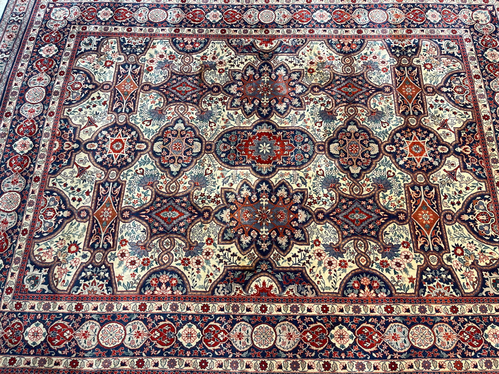 A Handwoven wool Oriental Rug: A Handwoven wool Oriental Rug measuring 6 feet wide by 9 feet 2 inches long. A finely woven wool hand knotted rug.