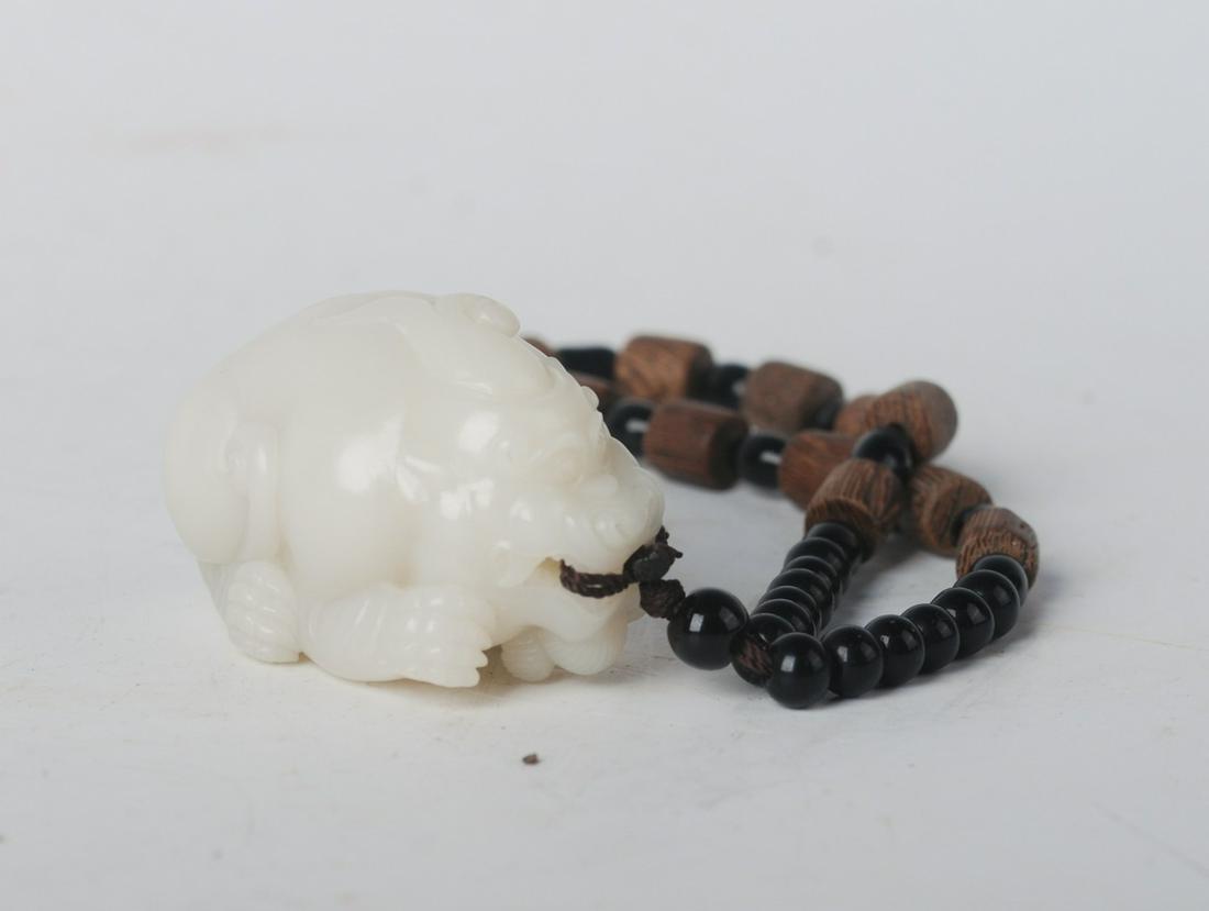 CHINESE WHITE JADE BEAST PENDANT: Length: 2.2 inches. Width: 1.4 inches. Height: inches. Length: 5.5cm Width: 3.5cm Height: 3.5 Weight: 98.6g. Provenance: From the collections of Mr. Matthew Choi estates from Rochester, NY.