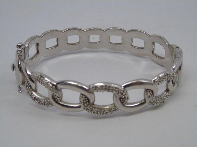 VINTAGE MARCASITE AND SILVER BANGLE BRACELET: A vintage Vintage Marcasite and Silver Bangle Bracelet. Linked Chain motif. Interior diameter is 2.75 inches.