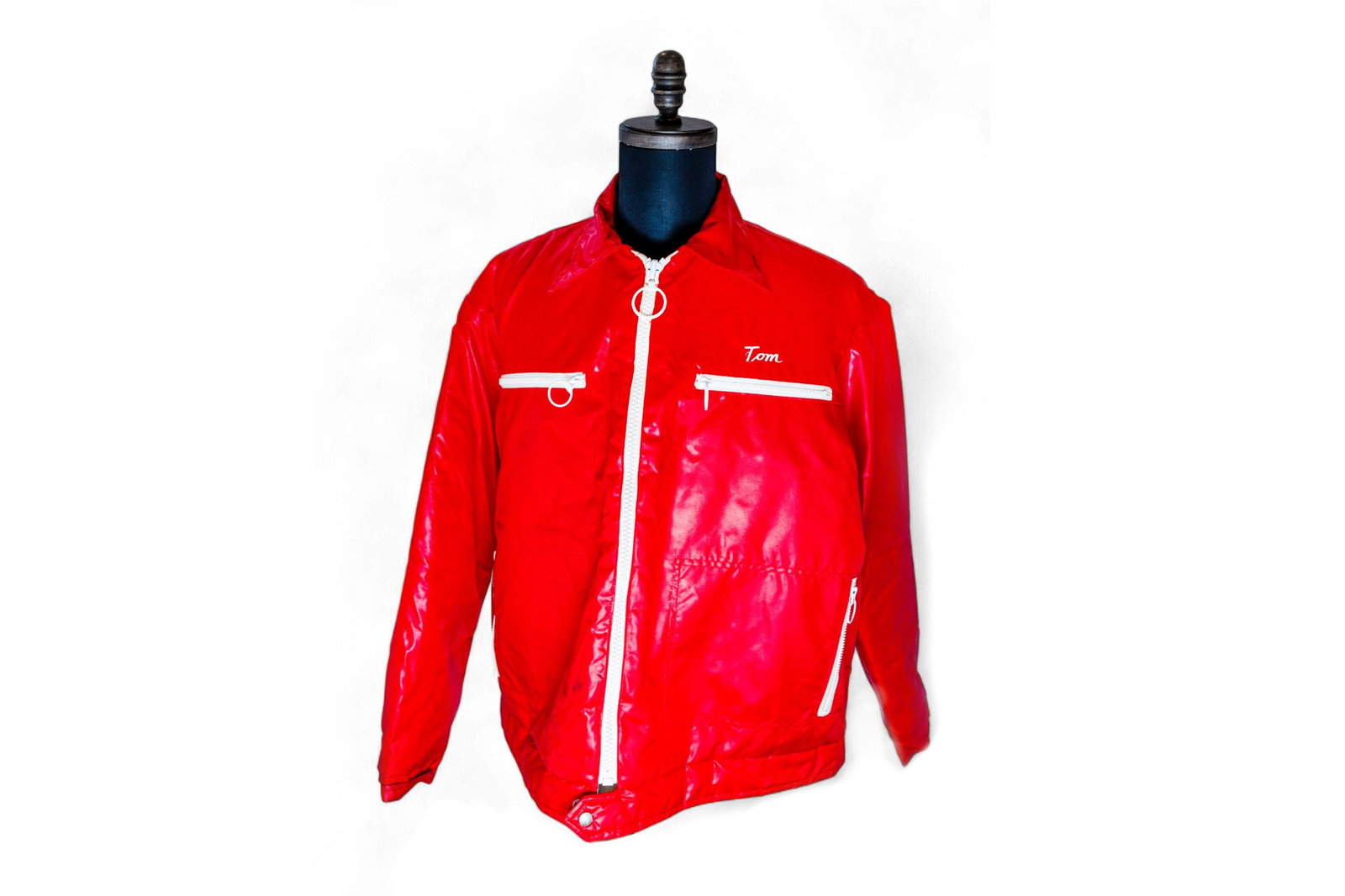 A Red Edelbrock jacket, polyester coat with zip-up front, 'Tom' embroidered on the left chest and (1 of 2)