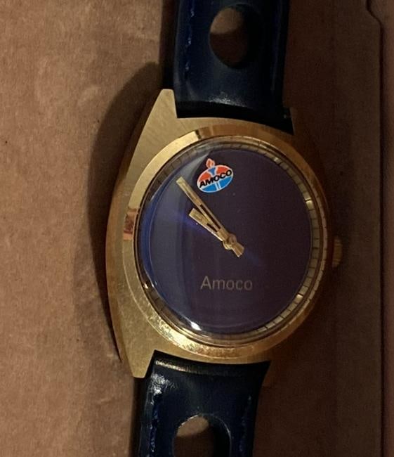 Amoco Animated 'Mystery' Dial Wristwatch, ca. 1970s: This watches feature a manual wind, and Seiko 17 jewel movement. The 'mystery' dial is an AMOCO logo that rotates around the dial. This men's watch has a gold plated case and is fitted with a new leat