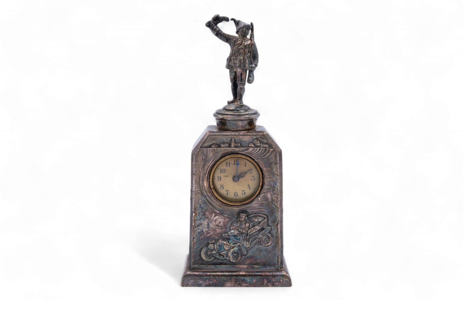 A silver-plated vintage German desk clock with an open seat touring car motif, circa 1910, engraved,: A silver-plated vintage German desk clock with an open seat touring car motif, circa 1910,engraved, 'Nelli 1910' on reverse, clock does not function, German Hunter on top, 7 H x 2.75 W x 1.5 L. Old pr