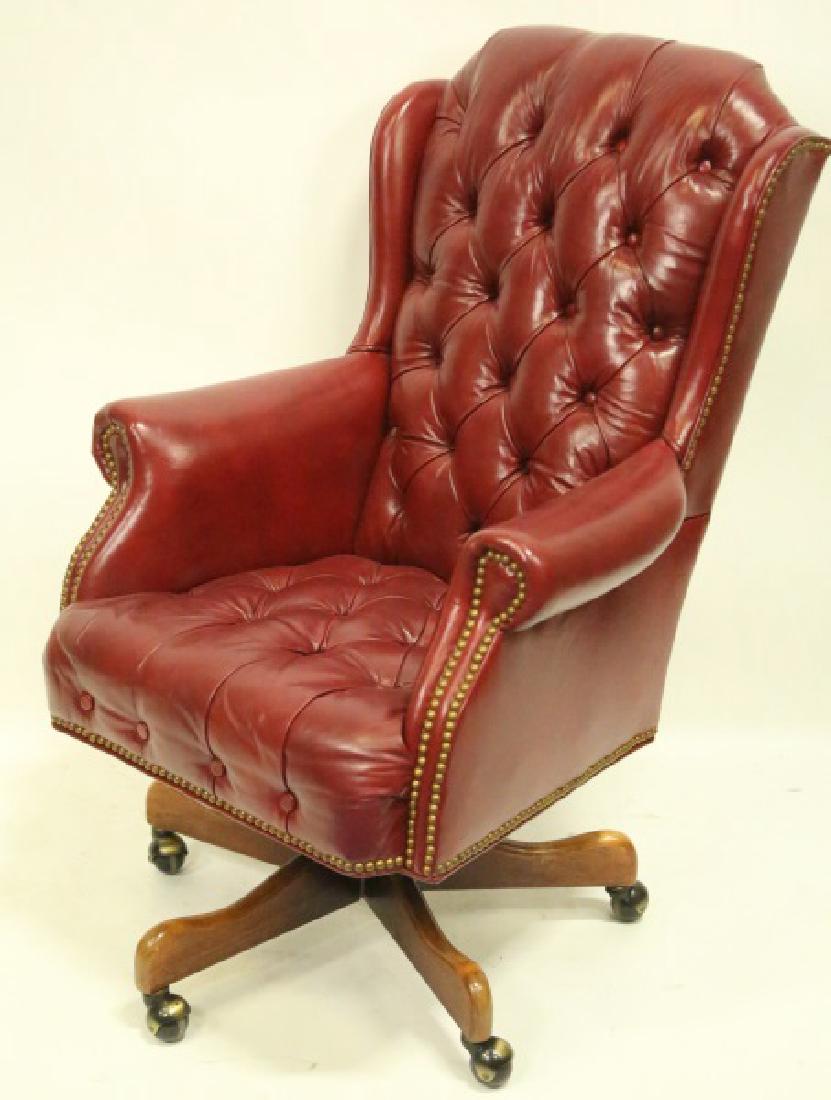 BUTTON-TUFTED RED LEATHER OFFICE WING CHAIR: BUTTON-TUFTED RED LEATHER OFFICE WING CHAIR WITH NAILHEAD TRIM ON CASTERS. Height: 43 in. by Width: 29 in. by Depth: 30 in.