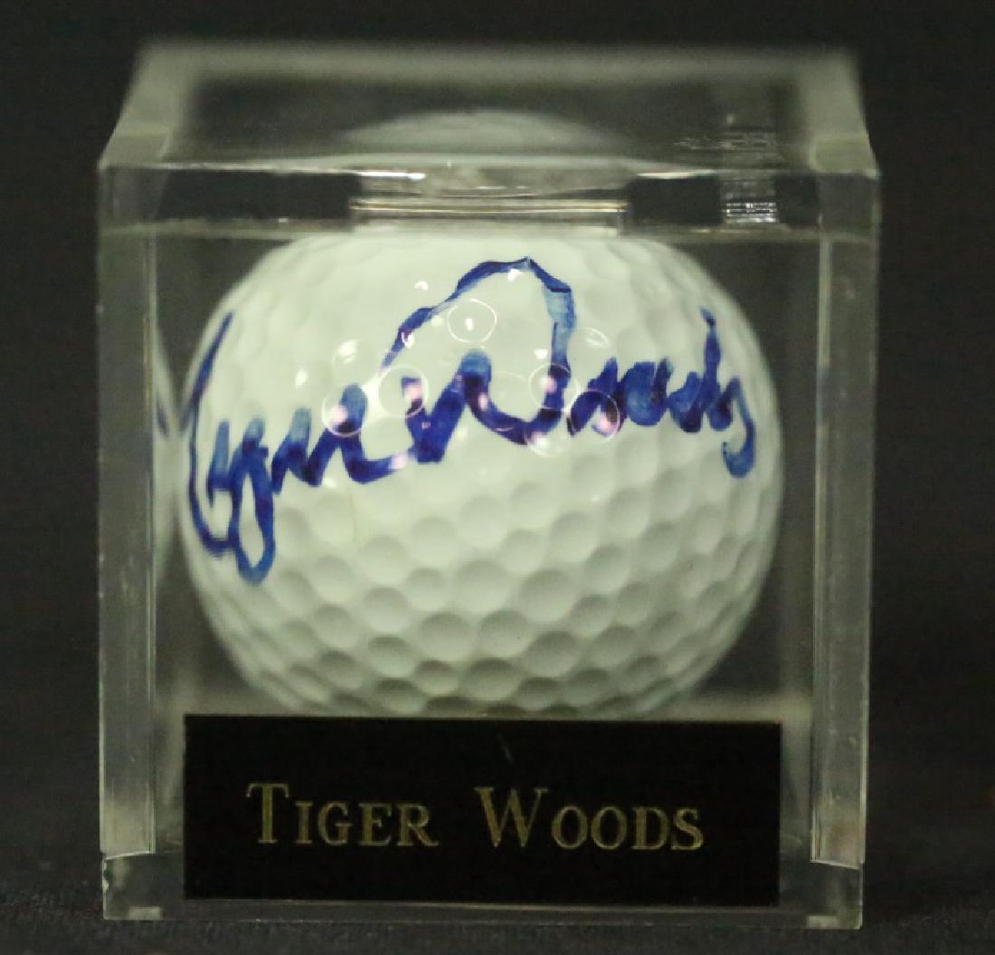 AUTOGRAPHED TIGER WOODS GOLF BALL: AUTOGRAPHED TIGER WOODS GOLF BALL IN LUCITE DISPLAY BOX.