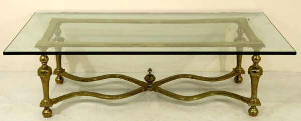 Brass coffee table with beveled glass top: Brass coffee table with beveled glass top Measurements: 60" x 32 x 18" Weight: 190 lbs