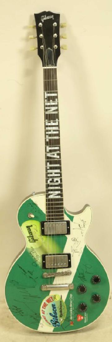 SIGNED GIBSON GUITAR FROM "2002 NIGHT AT THE NET".: SIGNED GIBSON GUITAR FROM "2002 NIGHT AT THE NET". SIGNED BY ANDRE AGASSI, MICHAEL BOLON, KELSEY GRAMMER, ANDY GRIGGS, GUSTAVO KUERTEN, JAMES McDANIEL, DO. PHIL MCGRAW, DENNIS MILLER, MUIQ, MATTHEW PE