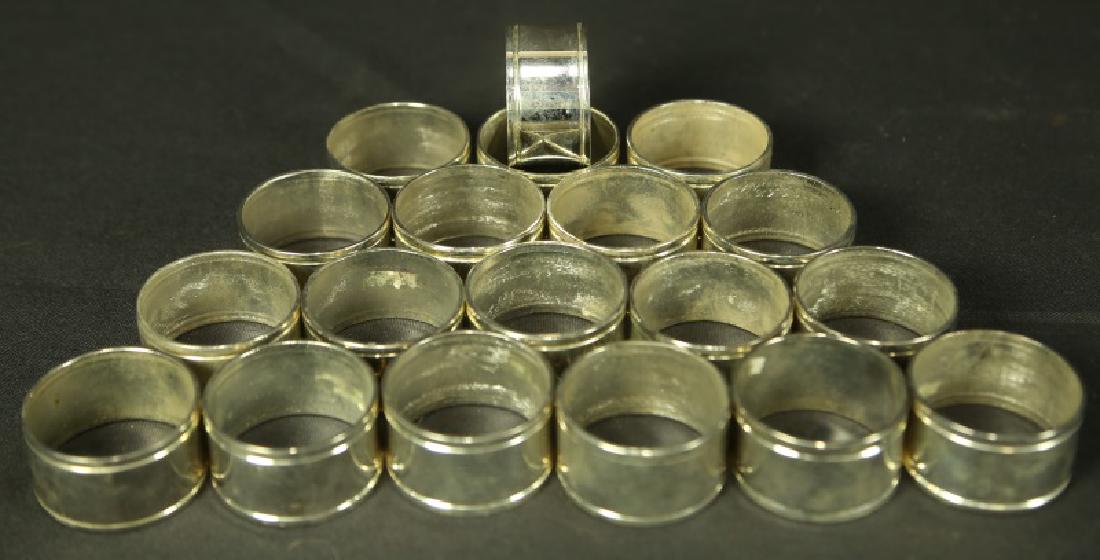 SET OF NINETEEN SILVER PLATED NAPKIN RINGS: SET OF NINETEEN SILVER PLATED NAPKIN RINGS. Height: 1 in. by Width: 2 in. by Depth: 2 in.