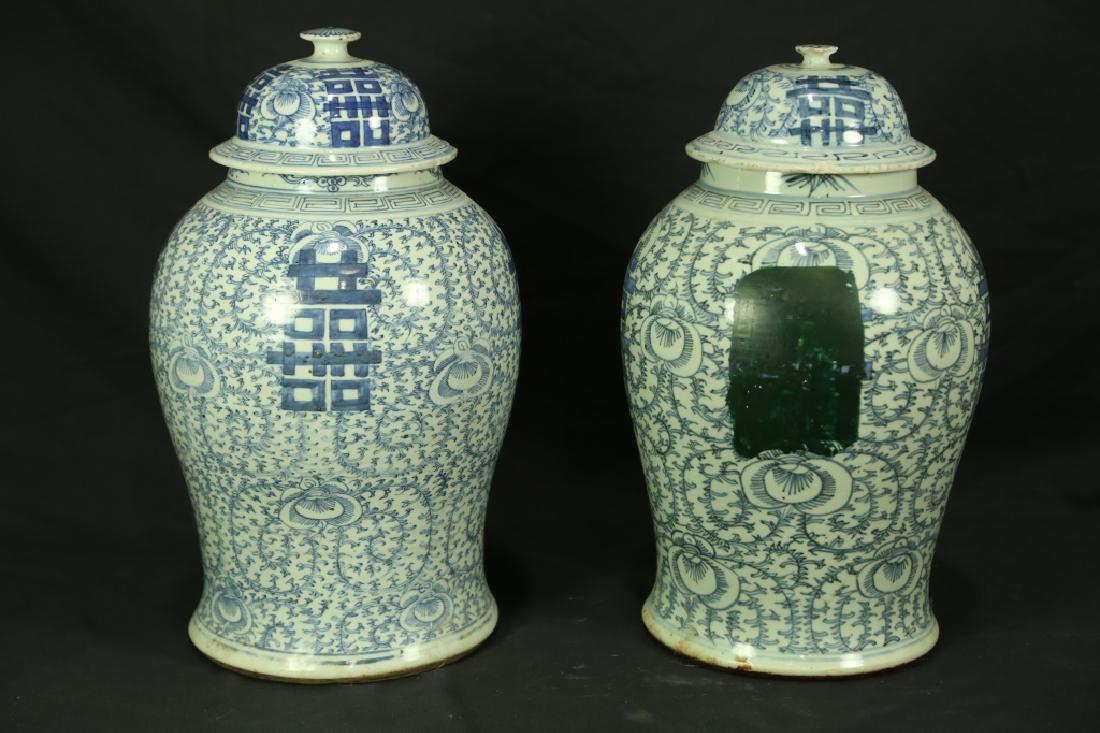 PAIR OF 19th DOUBLE HAPPINESS PORCELAIN JARS: PAIR OF 19th CENTURY DOUBLE HAPPINESS BLUE & WHITE PORCELAIN LIDDED JARS. ONE HAS BLACK PAINT "CULTURAL REVOLUTION MARK" ON IT. Some slight nicks on lids, sold as is. Height: 17 1/2 in. by Width: 12 i