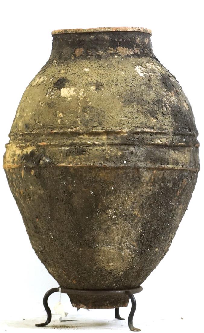 ANTIQUE TURKISH TERRACOTTA OLIVE JAR ON BASE: ANTIQUE TURKISH TERRACOTTA OLIVE JAR ON BASE. Height: 30 in. by Width: 25 in. by Depth: 25 in.