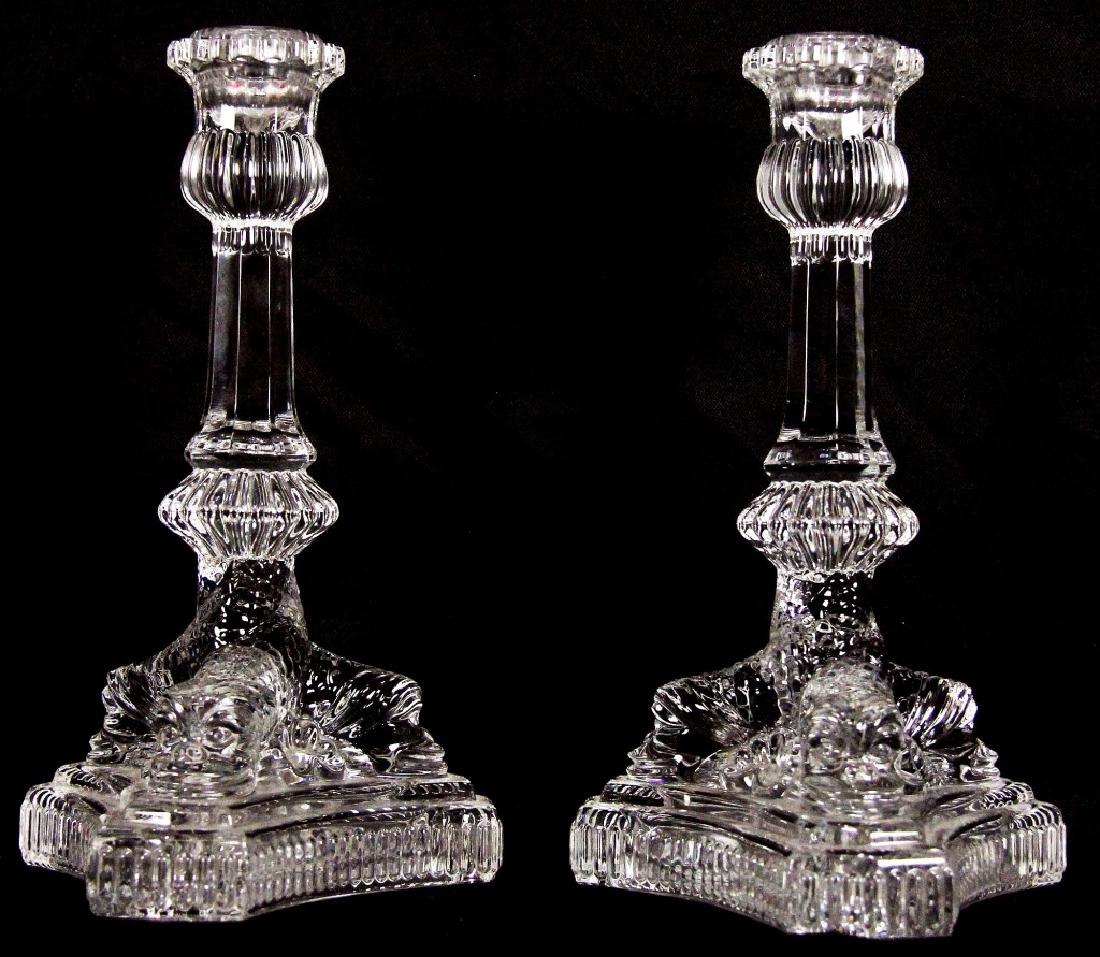 PAIR OF TIFFANY & CO. CANDLESTICKS: PAIR OF TIFFANY & CO. CANDLESTICKS WITH THREE DOLPHINS INTERTWINED TO SUPPORT COLUMN. Height: 8 in. by Width: 5 1/2 in. by Depth: 5 1/2 in.