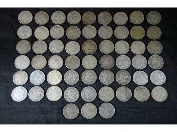 57 assorted coins. 32 Morgan dollars and 25 Peace