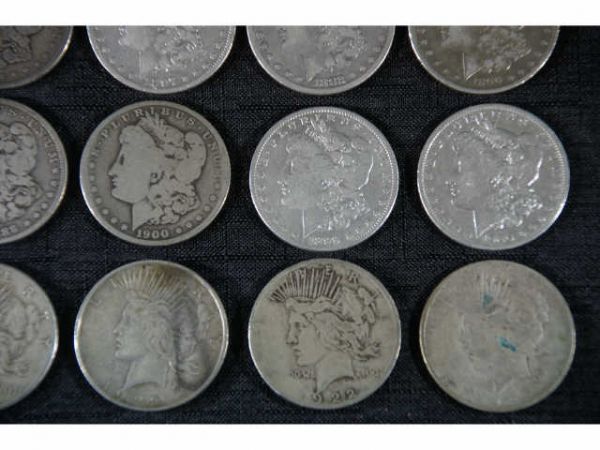 57 assorted coins. 32 Morgan dollars and 25 Peace - 2