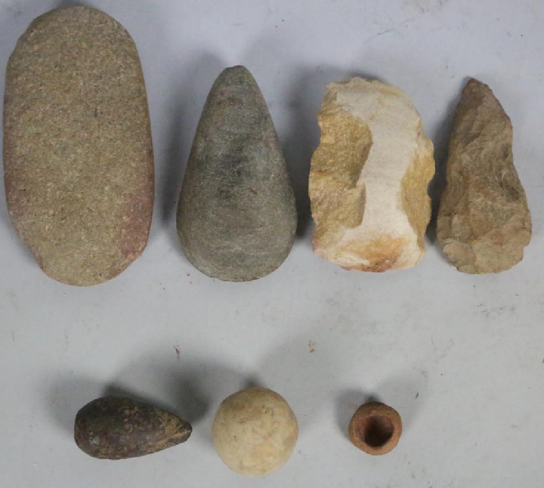MIXED LOT OF 7 PRE-HISTORIC NATIVE AMERICAN PIECES: MIXED LOT OF SEVEN PRE-HISTORIC NATIVE AMERICAN PIECES. THE BOX LOT INCLUDES SEVERAL UNREFINED CHOPPING TOOLS, GAME STONE & AX HEADS. Height: 7 in. by Width: 4 in. by Depth: 1 1/2 in.