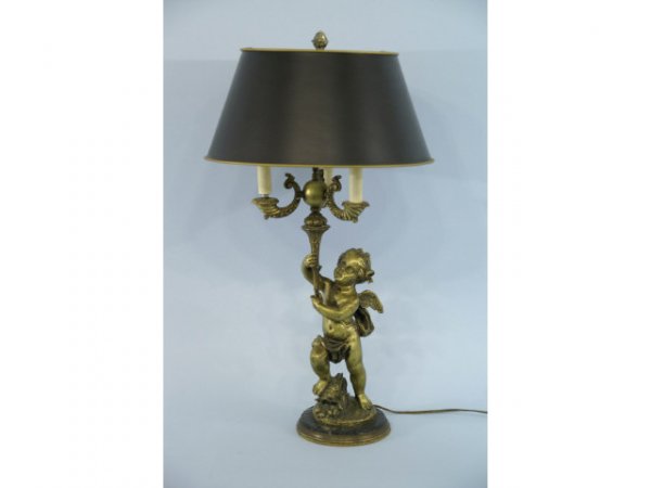 Lamp with a gilt cupid standing on a marble base.