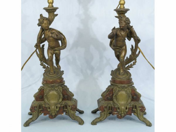 Pair of spelter lamps over red marble vases.