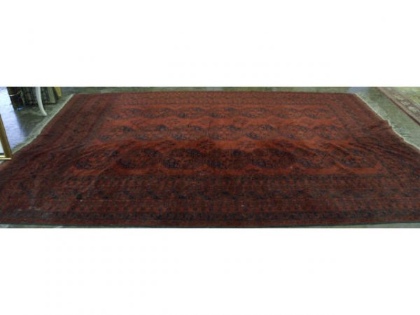 Large red rug with black designs.