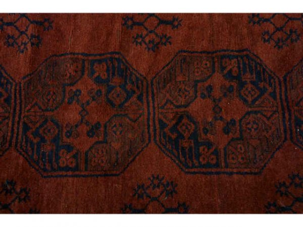 Large red rug with black designs. - 2