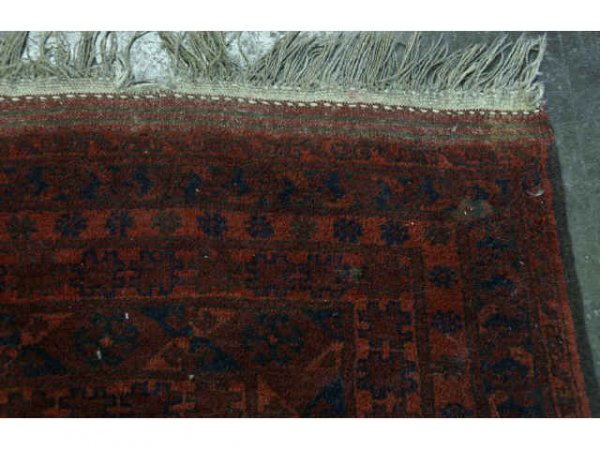 Large red rug with black designs. - 3