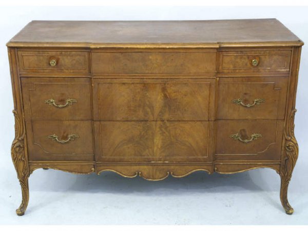 Three drawer sideboard with carved floral detail.