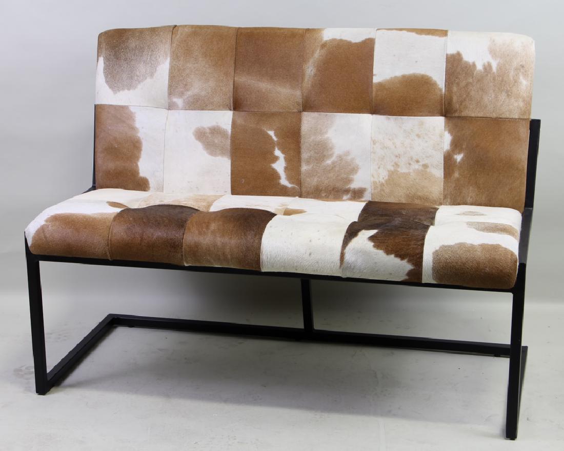 METAL BASE COWHIDE COVERED LOVESEAT: METAL BASE COWHIDE COVERED LOVESEAT. Height: 34 in. by Width: 48 in. by Depth: 24 in.