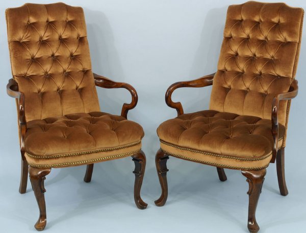 Pair of brown button-tufted armchairs.