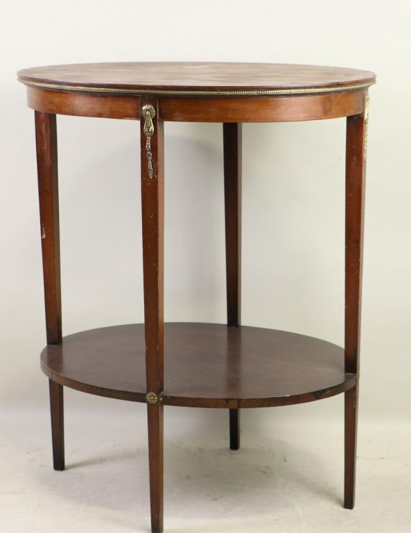 FRENCH TWO-TIER OVAL TABLE: FRENCH TWO-TIER OVAL TABLE. - FROM THE RUNNELS/FIRESTONE ESTATE. Height: 29 in. by Width: 24 in. by Depth: 18 1/2 in.