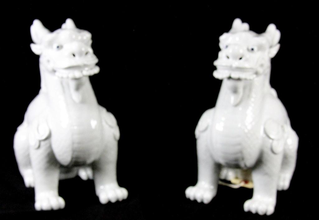 PAIR OF BLANC DE CHINE CHINESE PORCELAIN FOO DOGS.: PAIR OF BLANC DE CHINE CHINESE PORCELAIN FOO DOGS. Height: 9 1/2 in. by Width: 10 in. by Depth: 6 in.