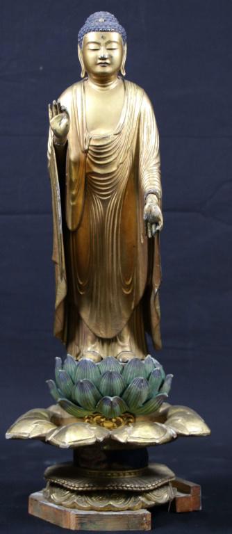 WOOD CARVED BUDDHA ON BASE: WOOD CARVED BUDDHA ON BASE. BASE IS DAMAGED AND IS SOLD AS IS. Height: 21 in. by Width: 8 1/2 in. by Depth: 8 1/2 in.