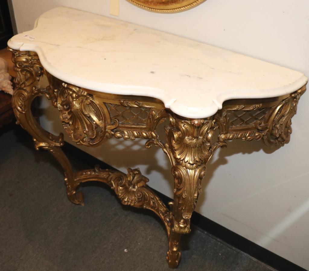 CIRCA 1780 BAROQUE GILDED MARBLE TOP CONSOLE TABLE: CIRCA 1780 BAROQUE GILDED MARBLE TOP CONSOLE TABLE. PROVENANCE: FROM THE LATE WILLIAM PEYTON ESTATE. MATCHES LOT 114. Height: 37 in. by Width: 43 in. by Depth: 18 1/2 in.