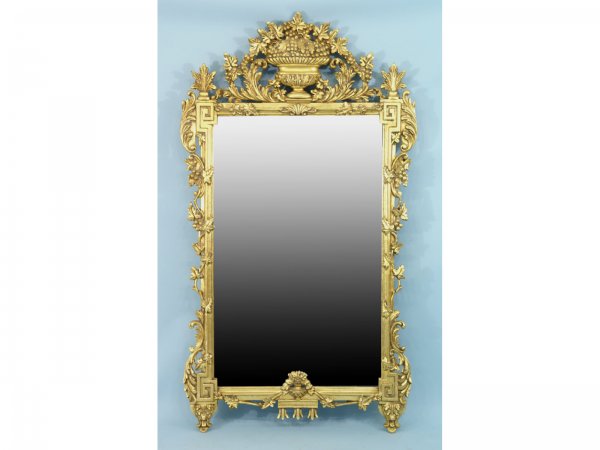 ORNATELY CARVED AND GILTWOOD BEVELED MIRROR